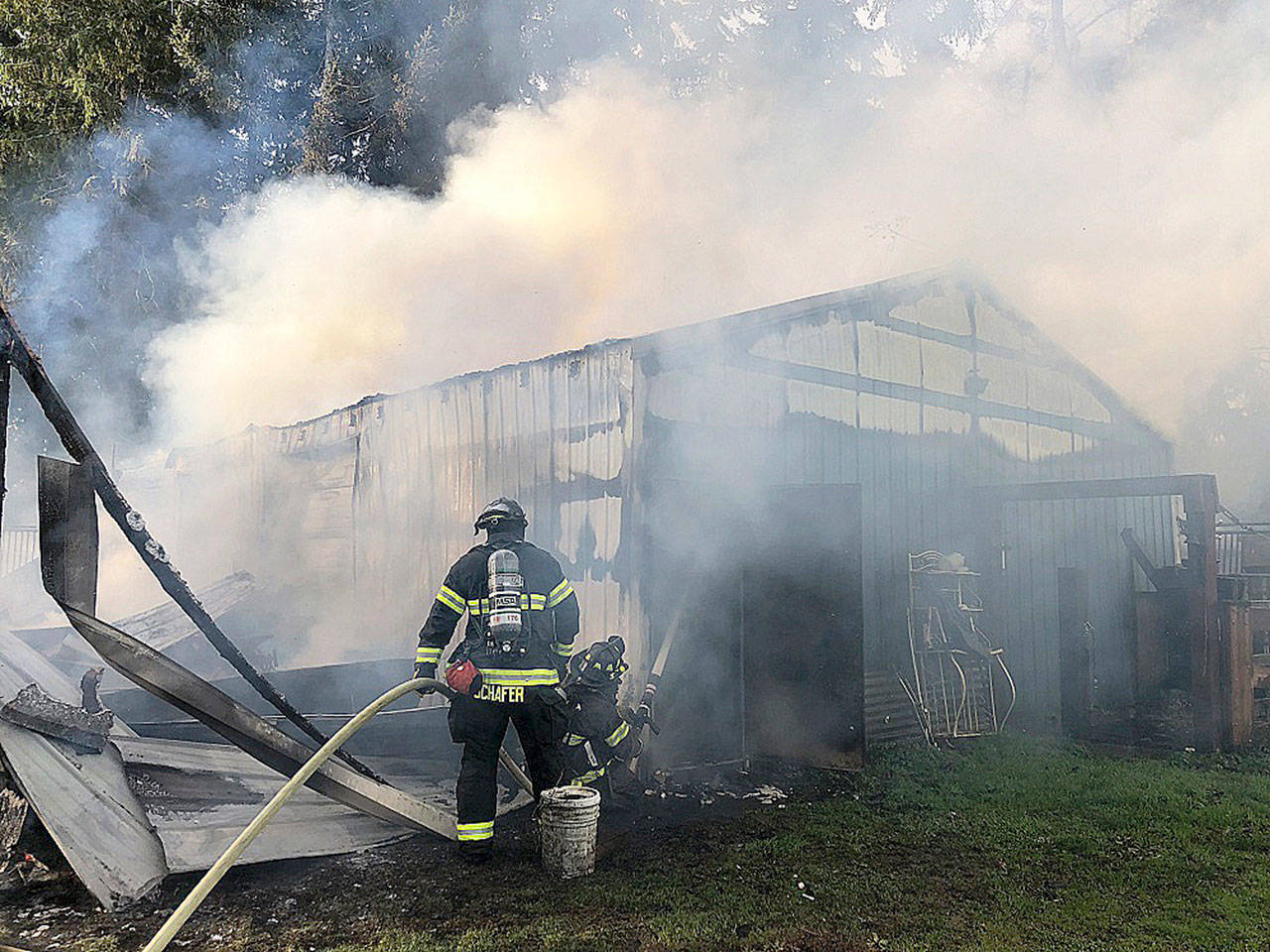 Firefighters battle a blaze early Monday morning at a Kent barn in the 12900 block of Southeast 203rd Place. COURTESY PHOTO, Puget Sound Fire