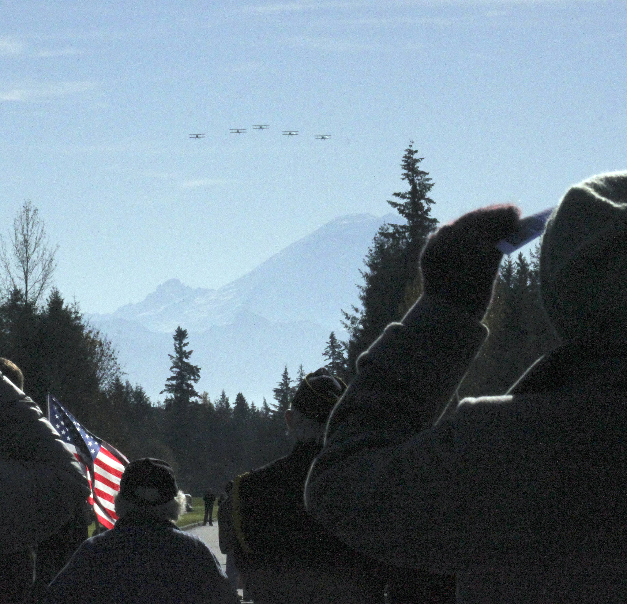 Stearman World War I vintage biplanes, led by pilot Rich Aldridge, approach to fly over Tahoma National Cemetery as honored guests stand during the Veterans Day ceremony last Sunday. SARAH BRENDEN, Covington-Maple Valley Reporter