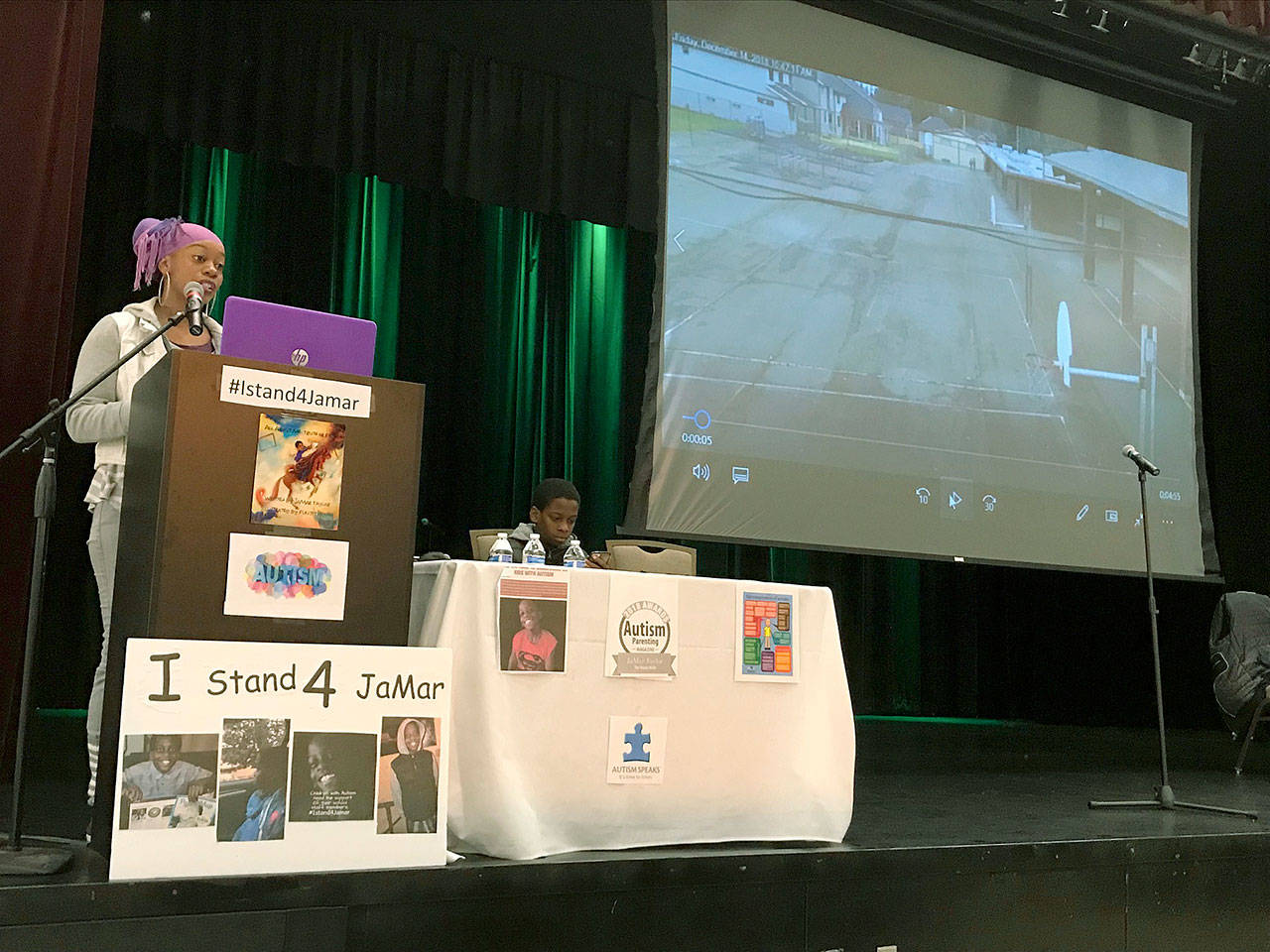 JaVohn Perry talks about her autistic son, JaMar Taylor, right, as she shows video footage from the Springbrook Elementary School surveillance system at a Feb. 2 rally at Green River College in Auburn. Perry claims her son was locked out of his school, left unsupervised to wander about in the cold for about 15 minutes trying to re-enter the building. MARK KLAAS, Kent Reporter