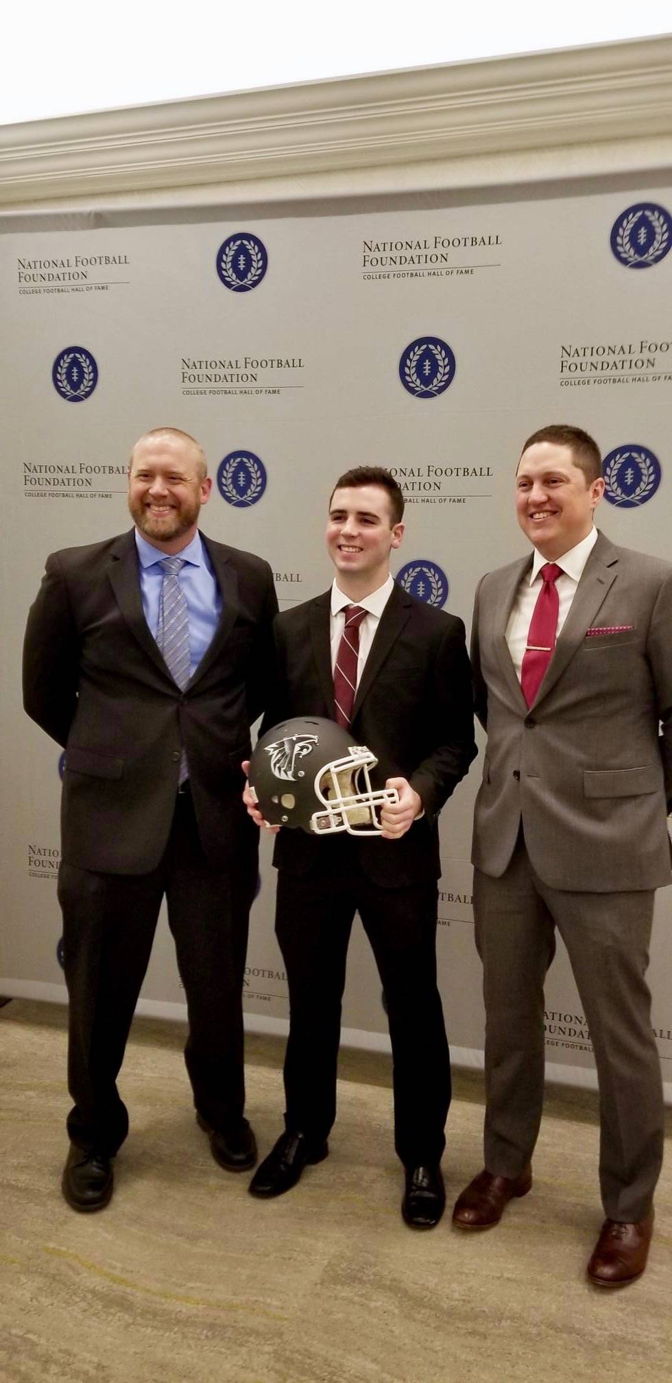 Hudson Potts receives his award with his coaches, Brett Thompson, left, and Kevin Hurt. COURTESY PHOTO