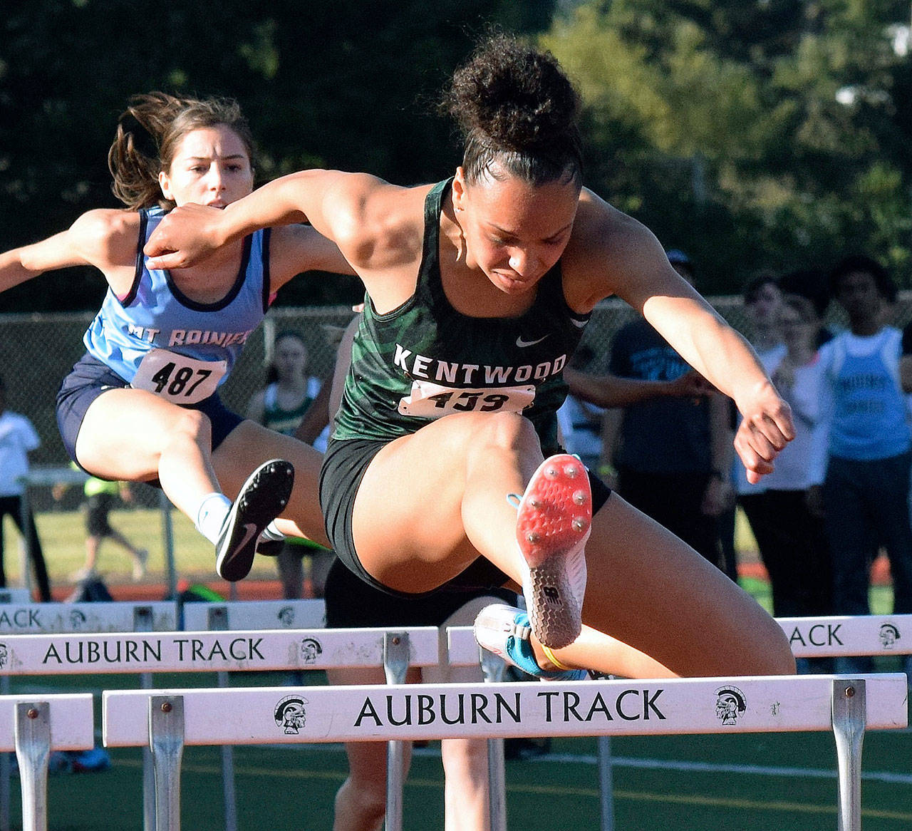 Kentwood’s Faith Marshall charges to a third-place finish in the NPSL 100-meter hurdles with a personal-best 14.71 seconds. RACHEL CIAMPI, Kent Reporter