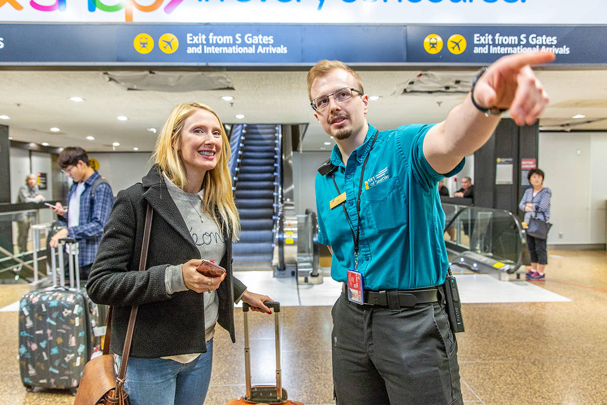 Airport Pathfinder, Evan Larson, helping travelers at Sea-Tac.