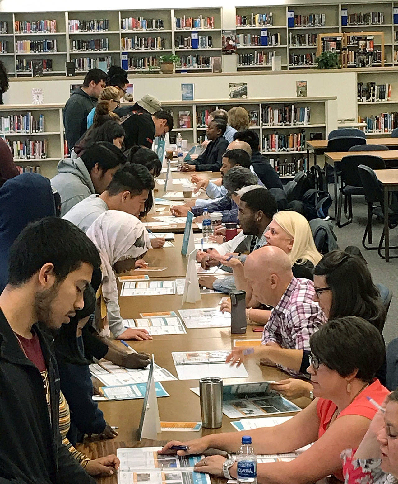 Volunteers from the business and financial organizations guided Kent-Meridian students on how manage money at the recent Financial Reality Fair. COURTESY PHOTO