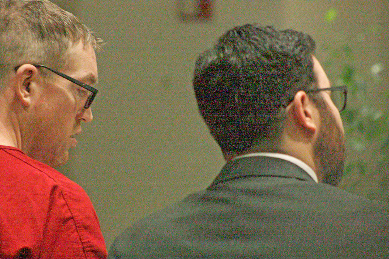 Nicholas Slater, left, listens in as his attorney, Deputy Public Defender Michael Schueler, talk to King County Superior Court Judge Karen Donohue during Slater’s arraignment for vehicular homicide on Monday, March 18 in Kent. MARK KLAAS, Kent Reporter