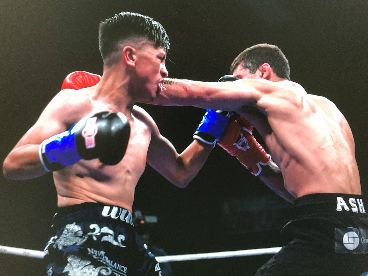 Willie Gomez, left, exchanges punches with Hamilton Ash during their four-round welterweight bout at the Emerald Queen Casino in Tacoma on Sept. 7. COURTESY PHOTO