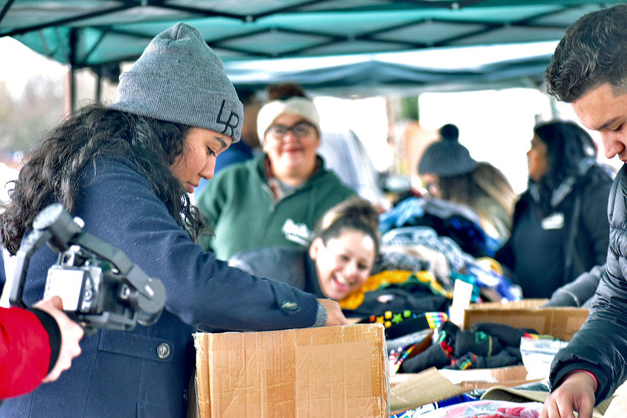 Volunteers for the Lord Riderz Christian Car Club organize clothing, blanket, shoes and other selections for those in need during their Homeless Outreach Event in Kent last Saturday. COURTESY PHOTO