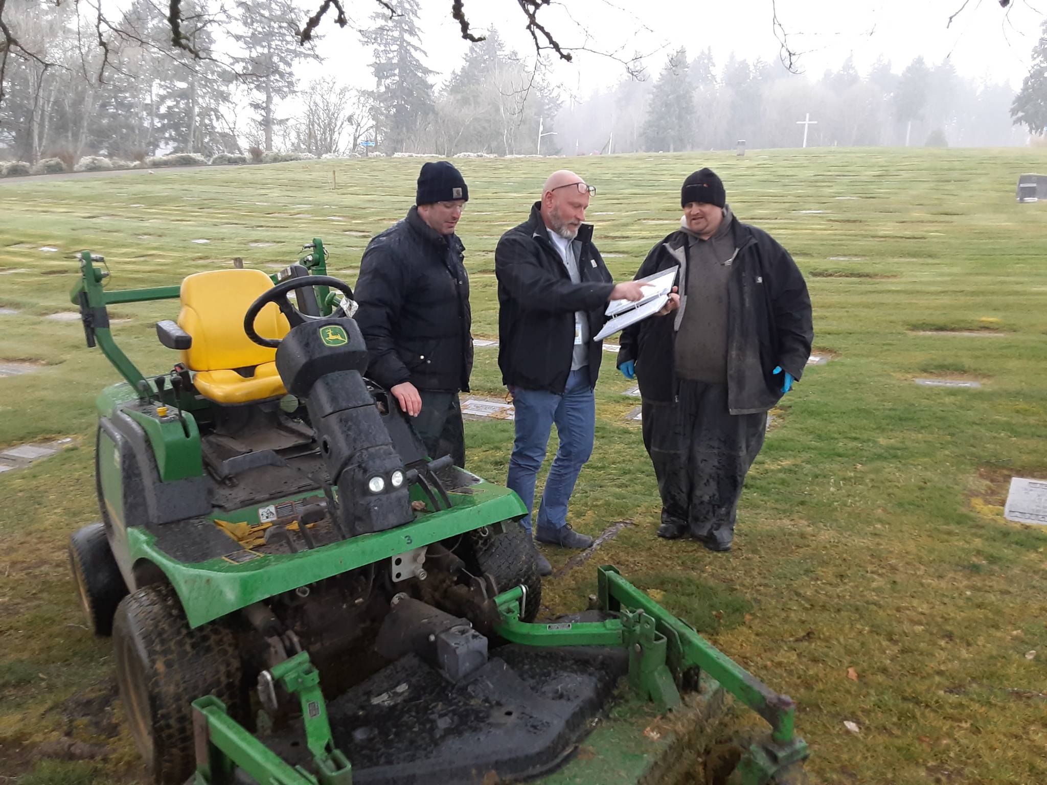 Auburn Mountain View Cemetery Manager Craig Hudson, center, confers with two maintenance workers. ROBERT WHALE, Auburn Reporter