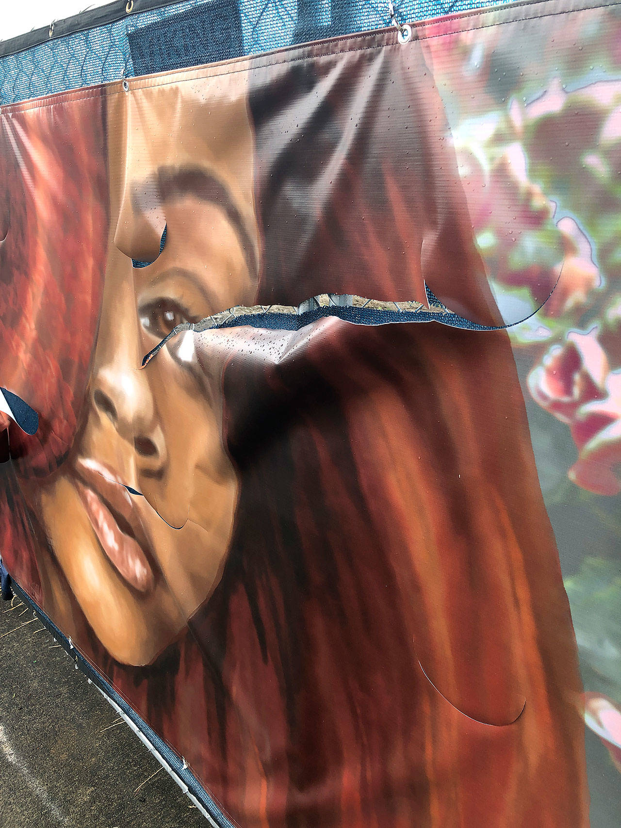 The face on a mural created by Jasmine Iona Brown has been slashed multiple times. Photo courtesy of Sound Transit