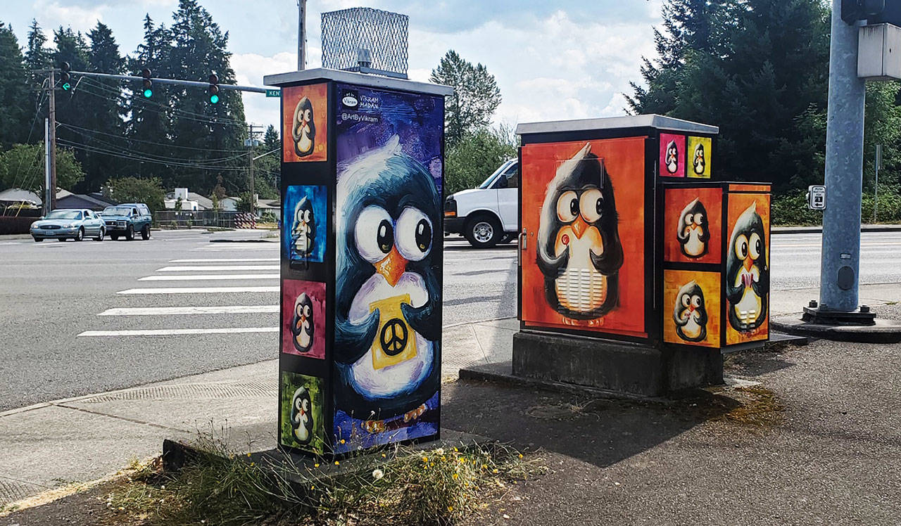 Vikram Madan’s “Perplexed Penguins” peer out from a striking color-block background at SE 272nd Street (Kent-Kangley Rd.) and 152nd Avenue SE. The curious little birds appear holding a variety of fanciful objects, from hearts and butterflies to lollipops and a tiny accordion. COURTESY PHOTO, City of Kent