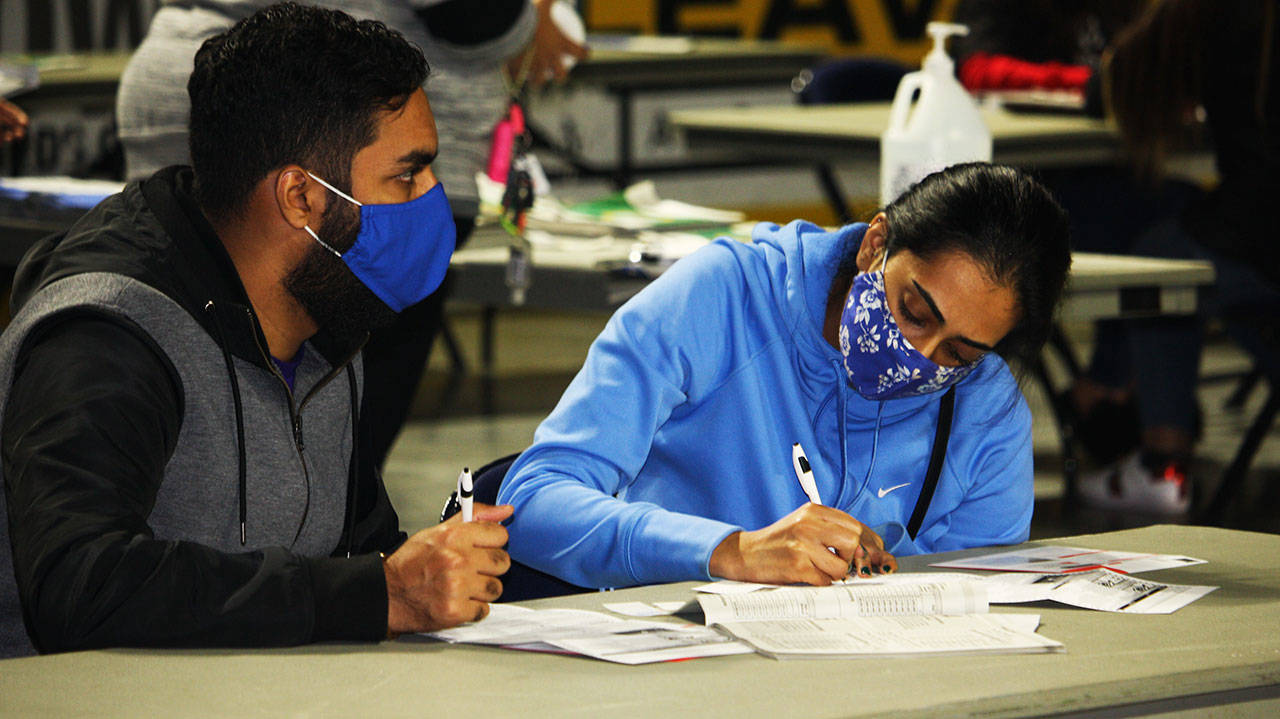 Two voters fill out their ballots Tuesday, Nov. 3 at the Vote Center inside the accesso ShoWare Center in Kent. STEVE HUNTER, Kent Reporter