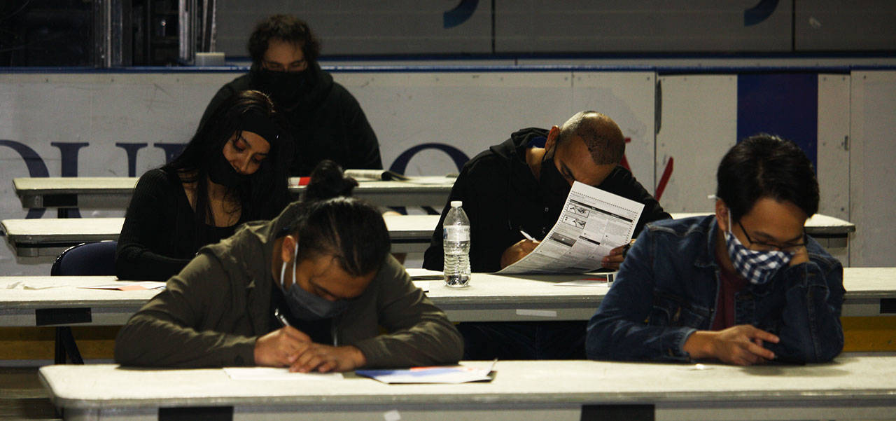 Voters fill out ballots Tuesday, Nov. 3 at the Vote Center inside the accesso ShoWare Center in Kent. STEVE HUNTER, Kent Reporter