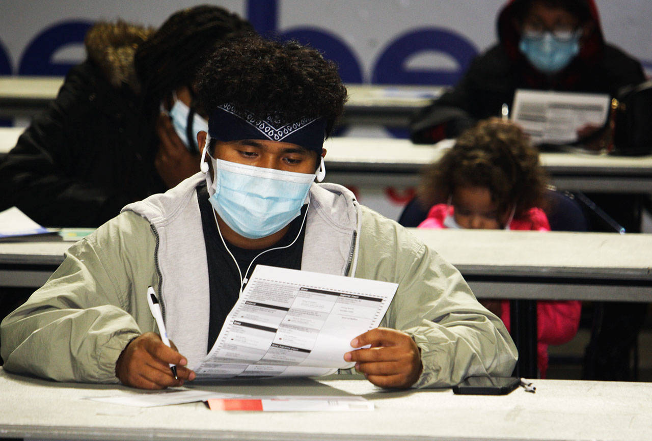 A man prepares to fill out his ballot at the Vote Center Tuesday, Nov. 3 inside the accesso ShoWare Center. STEVE HUNTER, Kent Reporter