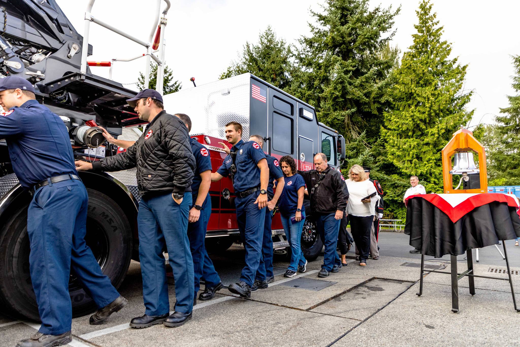 Kent Mayor Dana Ralph, in the back, joins firefighters at Puget Sound Fire Station 74 on Aug. 9 to dedicate a new ladder truck. COURTESY PHOTO, Puget Sound Fire