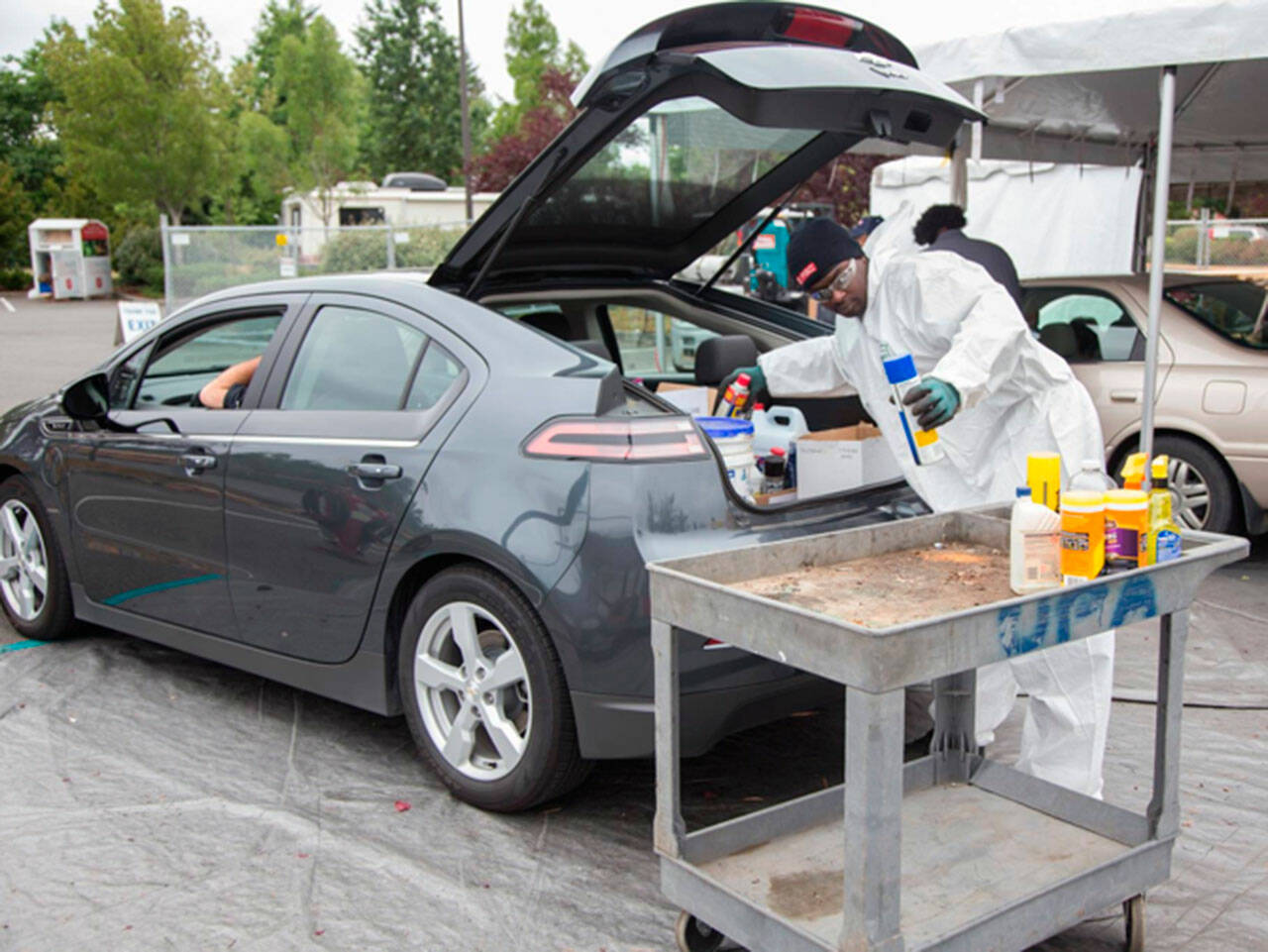 A King County staff member removes hazardous materials dropped off by a resident. COURTESY PHOTO, King County