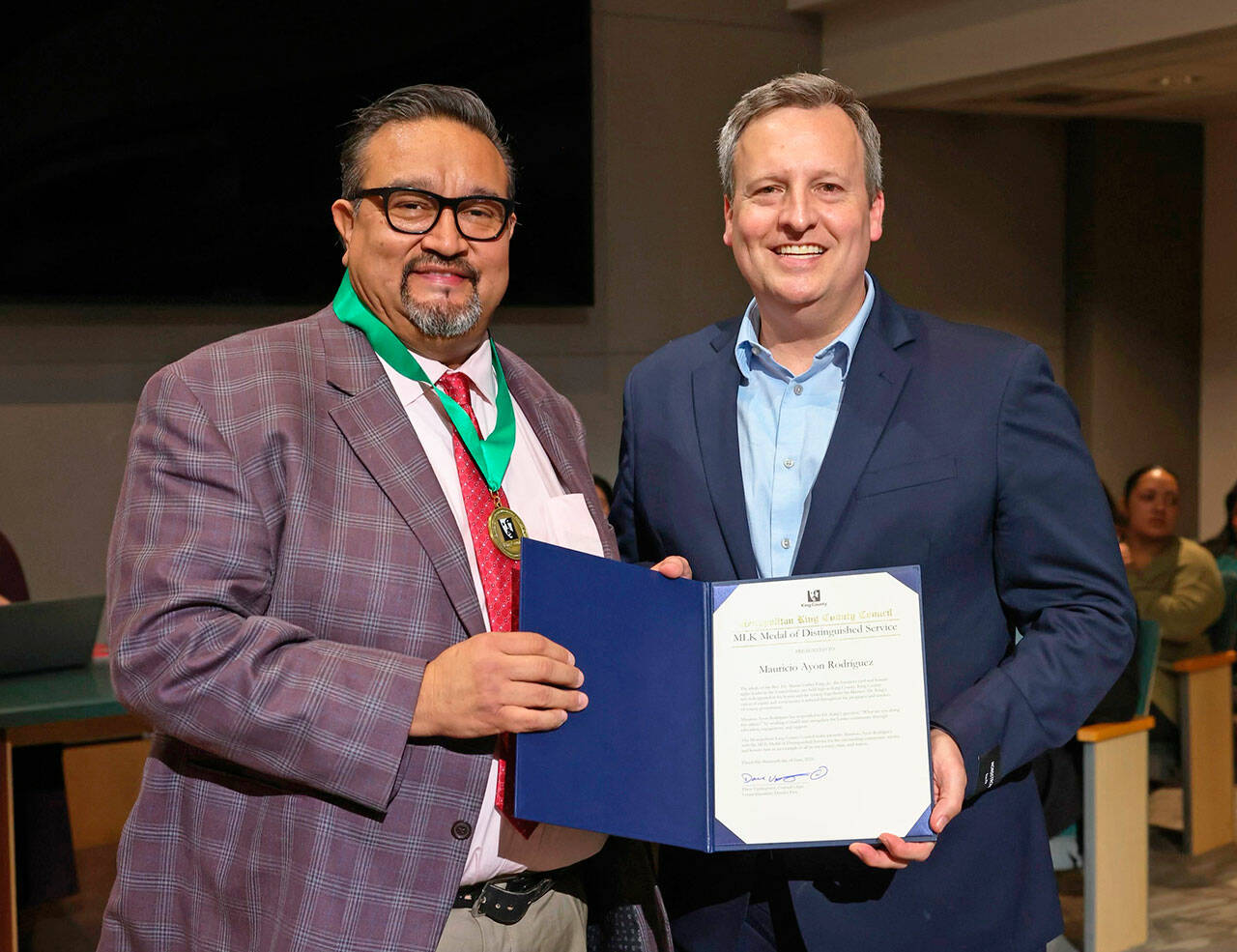 Mauricio Ayon Rodriguez, left, receives a MLK Distinguished Service honor from King County Councilmember Dave Upthegrove. COURTESY PHOTO, King County