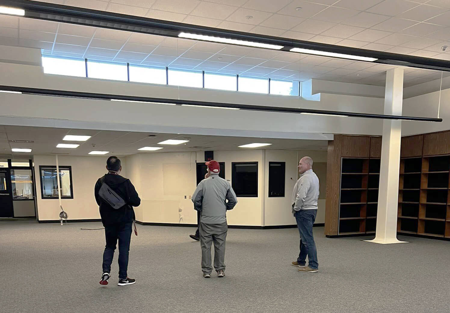 Kent School Board President Joe Bento, left, board member Tim Clark and district administrator Wade Barringer tour the new library at Canyon Ridge Middle School. COURTESY PHOTO, Leslie Hamada