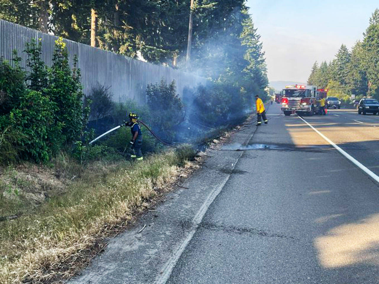 Puget Sound Fire battles a brush fire July 4 along westbound Highway 18, just west of the SE 256th Street exit. COURTESY PHOTO, Puget Sound Fire