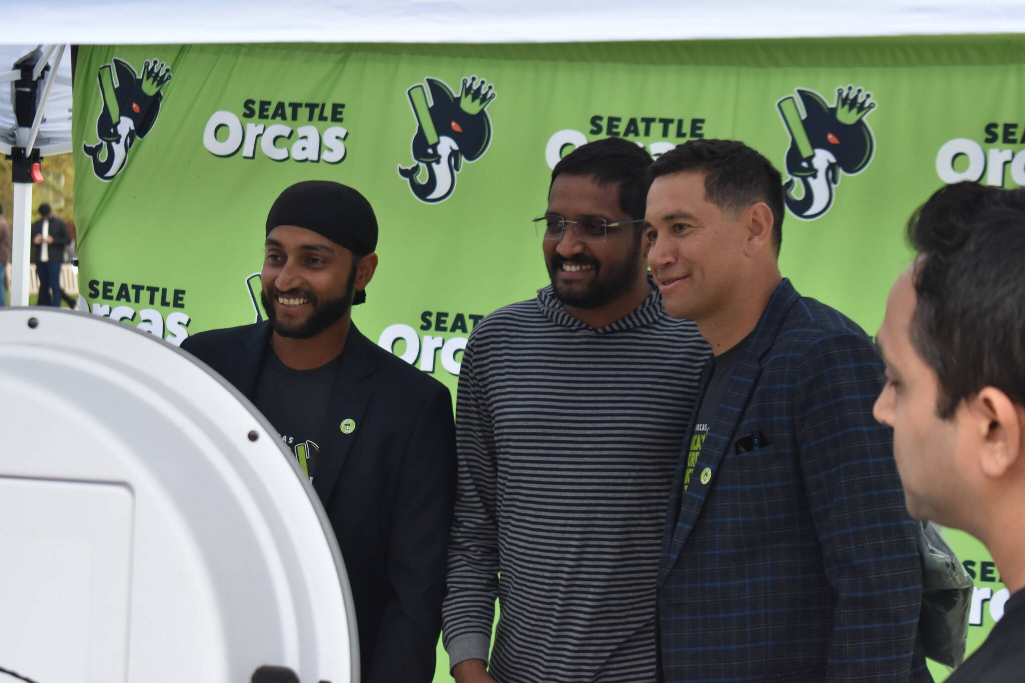 Harmeet Singh (right) and Ross Taylor (left) take a photo with a fan at fan fest. Ben Ray / The Reporter