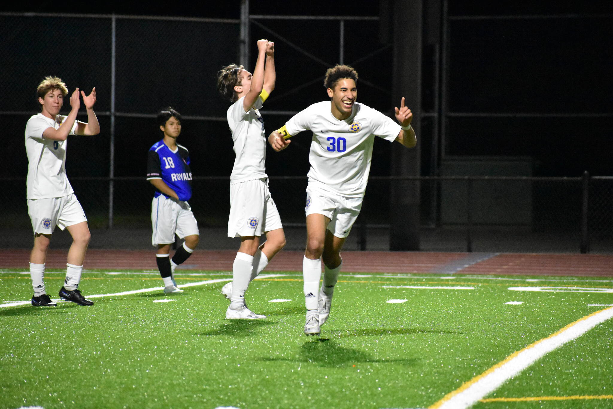 A trio of Tigers celebrate the win over Kent-Meridian. Ben Ray / The Reporter