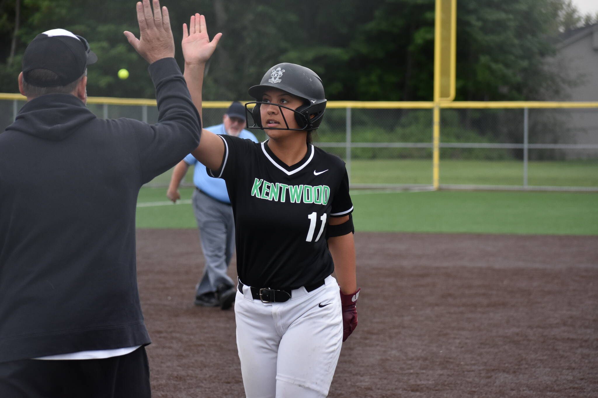 Joe Francis-Rodrigues gives a high-five after an RBI. Ben Ray / The Reporter