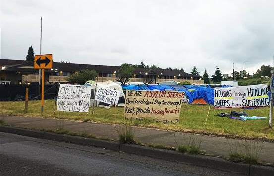 Asylum seekers set up camp Saturday, June 2, in Kent next to the former Econo Lodge, now vacant and owned by King County. Asylum seekers want the county and city of Kent to reopen the hotel for them. BAILEY JO JOSIE, Sound Publishing