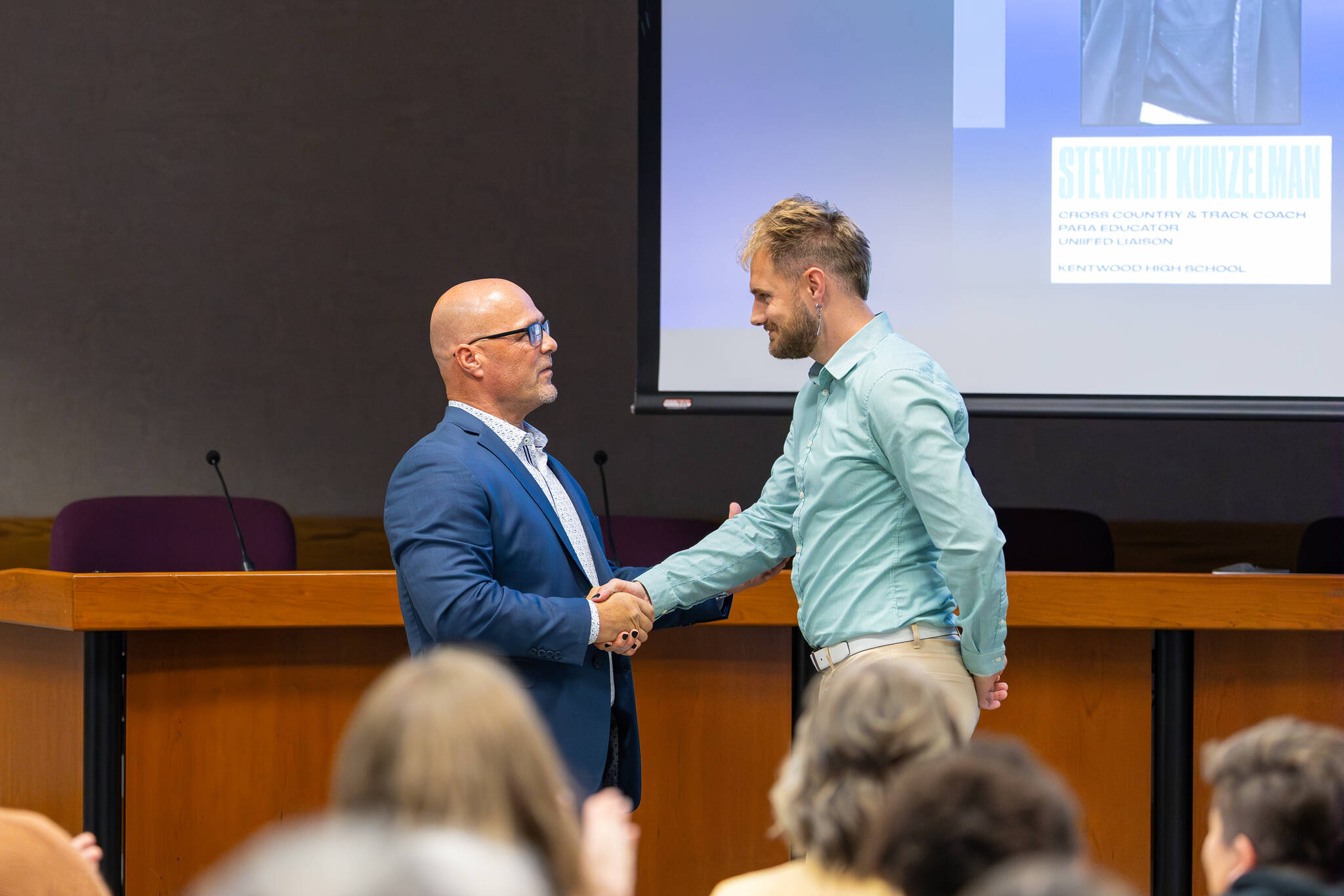 Kentwood High School cross country and track coach Stewart Kunzelman is recognized for his coaching efforts. Photo by Robby Mullikin