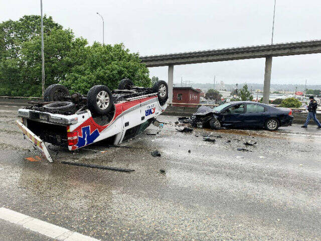 An American Medical Response vehicle flipped during a multiple vehicle crash June 2 on Interstate 5 in Seattle that killed Shanique Dickens, 26, of Kent. Dickens also had connections to Federal Way. COURTESY PHOTO, Washington State Patrol