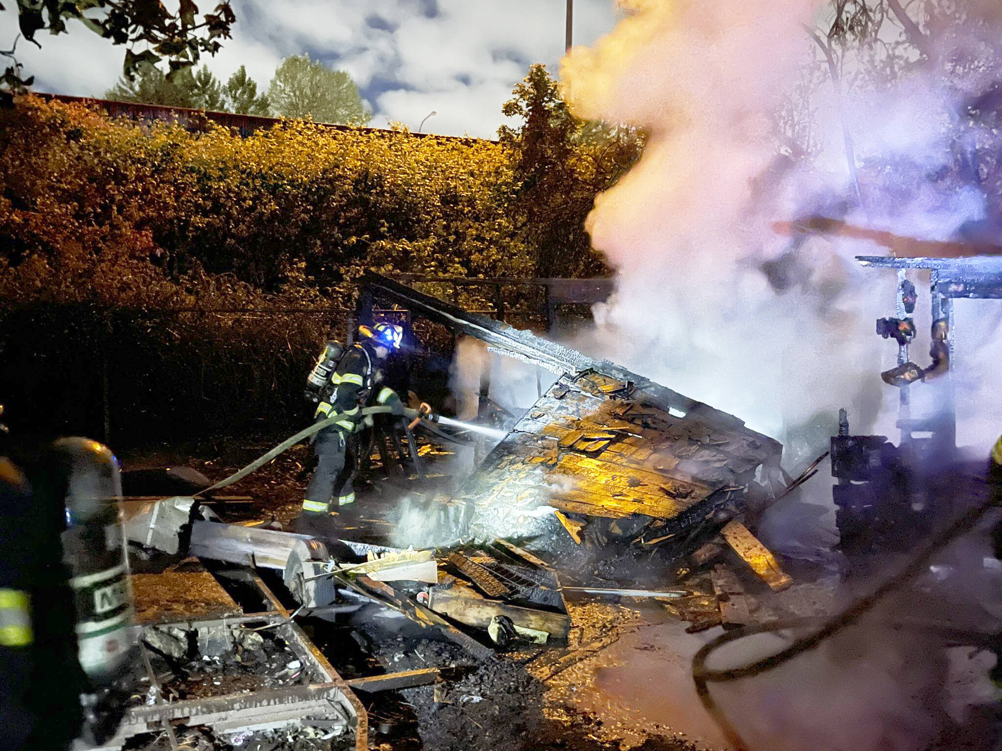 A firefighter battles a blaze Sunday, June 16 at a vacant home in the 100 block of Naden Avenue in Kent. COURTESY PHOTO, Puget Sound Fire