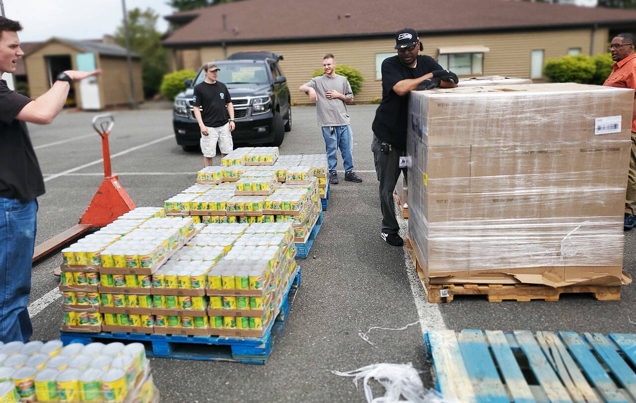 Volunteers help unload a semi of donated food for local organizations. COURTESY PHOTO