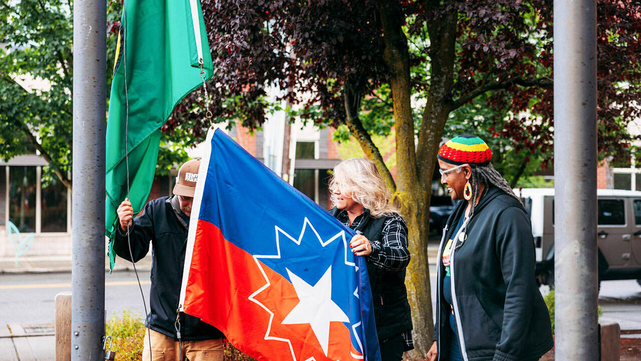 Kent Mayor Dana Ralph prepares to help raise the Juneteenth flag on Monday, June 17 at City Hall as Gwen Allen-Carston, executive director of the Kent Black Action Commission, looks on. COURTESY PHOTO, City of Kent