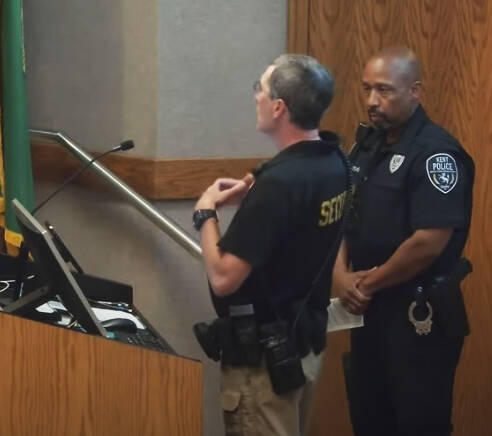 Tim Kovich, left, Kent School District supervisor of safety services and Kent Police Officer Kevin Strong, a school resource officer at Kentridge High, at the July 10 Kent School Board meeting. SCREENSHOT, Kent School District