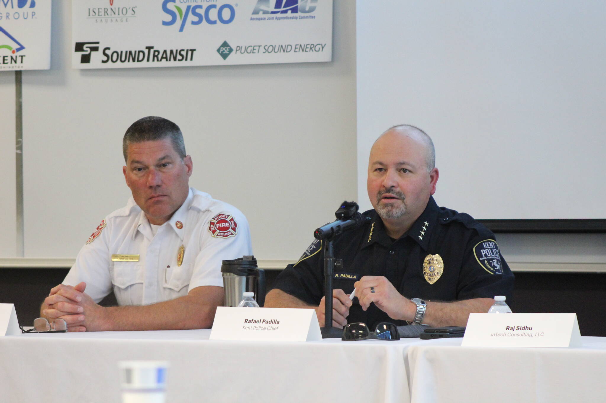 Puget Sound Fire Chief Brian Carson and Kent Police Chief Rafael Padilla discuss safety and security for Kent businesses. Photo by Bailey Jo Josie/Sound Publishing