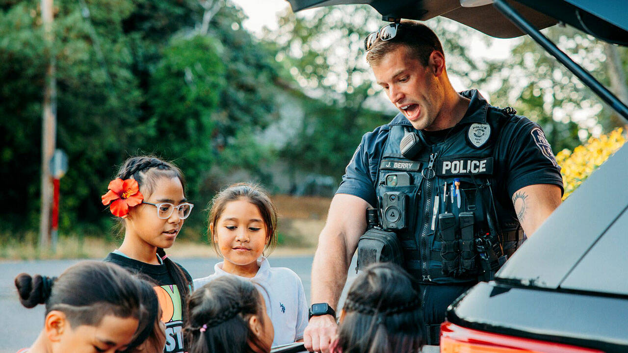 Kent Police Officer J. Berry interacts with children at a National Night Out event Tuesday, Aug. 6. COURTESY PHOTO, City of Kent