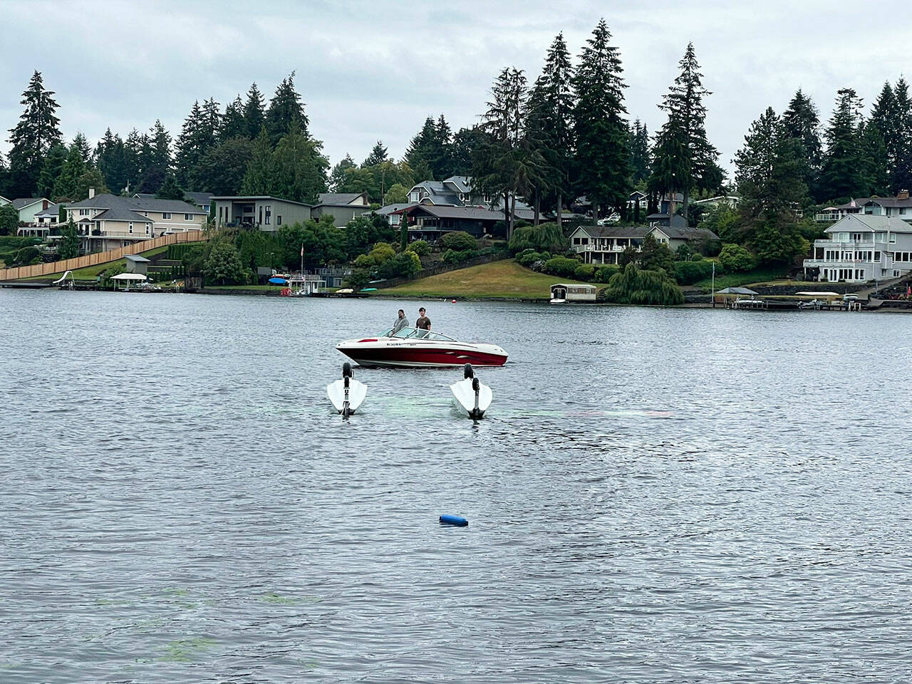 A boat near the upside down seaplane that crashed Saturday morning, Aug. 24 into Lake Meridian in Kent. COURTESY PHOTO, Puget Sound Fire