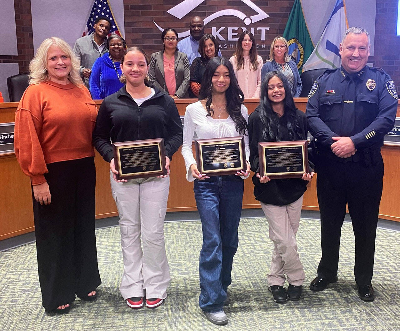 Kent Mayor Dana Ralph and Kent Police Deputy Chief Matt Stansfield pose Sept. 17 at the City Council meeting with the three girls who helped save a 6-year-old girl from an alleged attempted kidnapping July 16 at the Meridian Green Apartments. COURTESY PHOTO, City of Kent