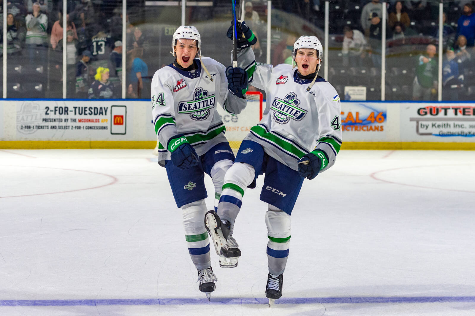 Brayden Holbertson (left) and Owen Boucher (right) celebrate the home opening win for the first of the season. Photo taken by Brian Liesse / The Seattle Thunderbirds