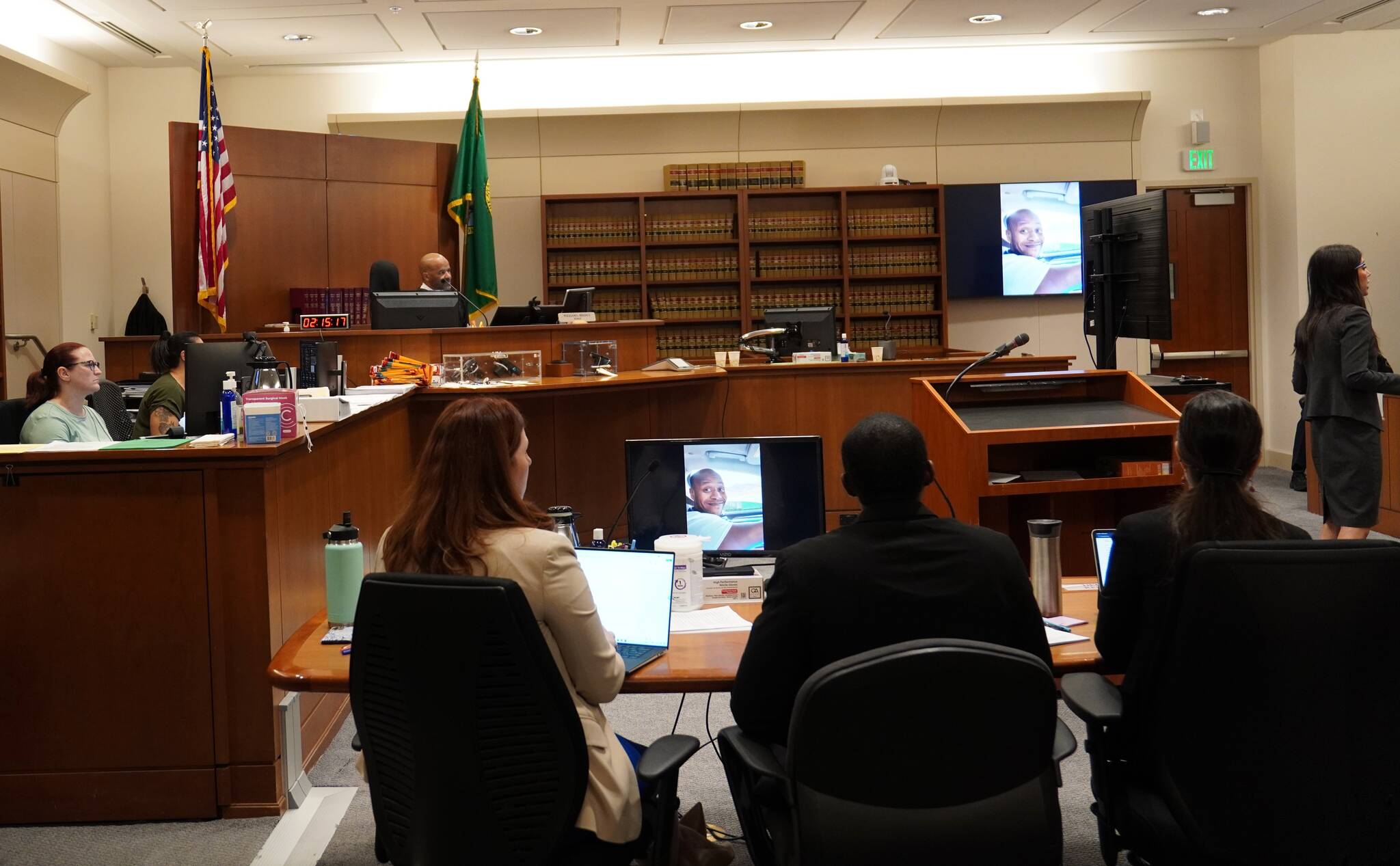 Corniche Washington in the black suit between his defense while the prosecutor delivered her closing statement. Photo by Joshua Solorzano/The Mirror