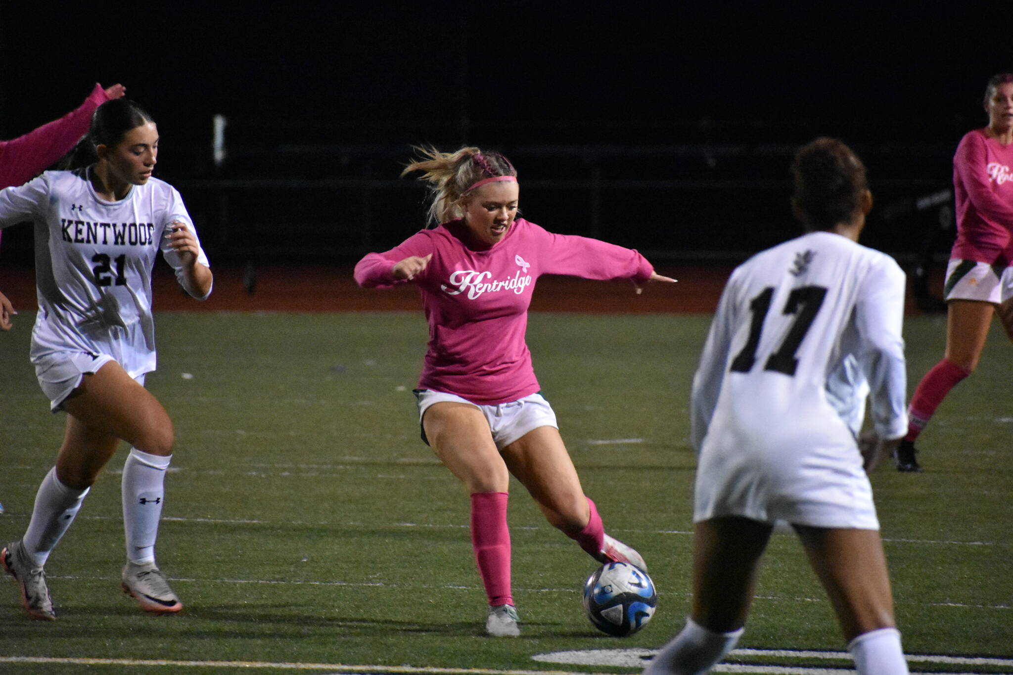 Mckenna Bennett in the middle of a pass to Shiney Mayanja for the Chargers’ sixth goal of the night. Ben Ray / The Reporter