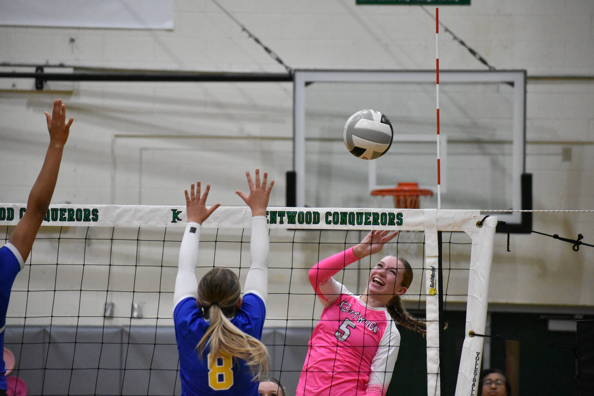 Kentwood senior Aly Skagen with a tip over the net for the Conks. Ben Ray / The Reporter