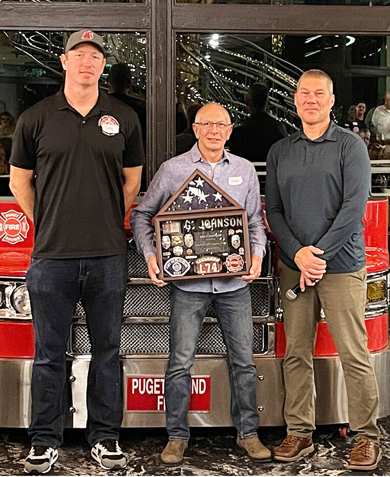 Puget Sound Fire engineer Greg Johnson, center, was one of 20 employees who retired this year and were recognized at an Oct. 19 ceremony by Cody Boyd, left, Puget Sound Firefighters 1747 vice president, and Puget Sound Fire Chief Brian Carson, right. COURTESY PHOTO, Puget Sound Fire