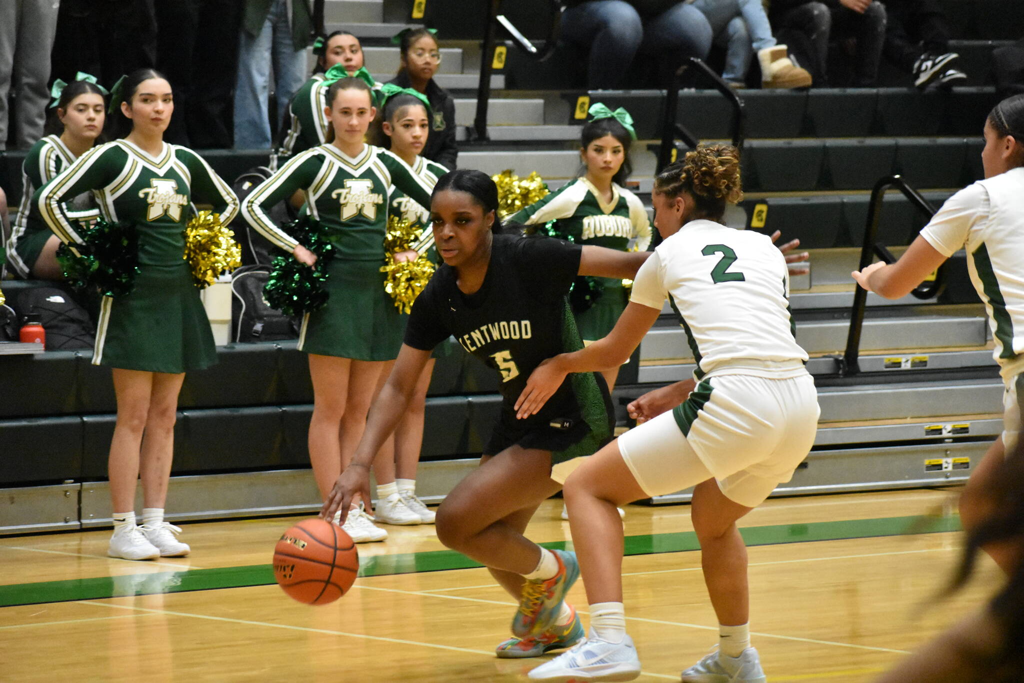 Kentwood senior Jessica Ajayi dribbles past an Auburn defender. Ben Ray / The Reporter