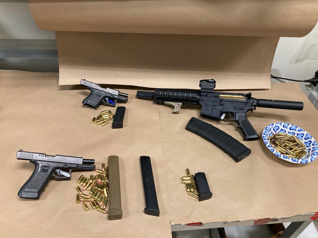 Three firearms and magazines reportedly retrieved from the suspect’s home and vehicle. Photo courtesy of Auburn Police Department