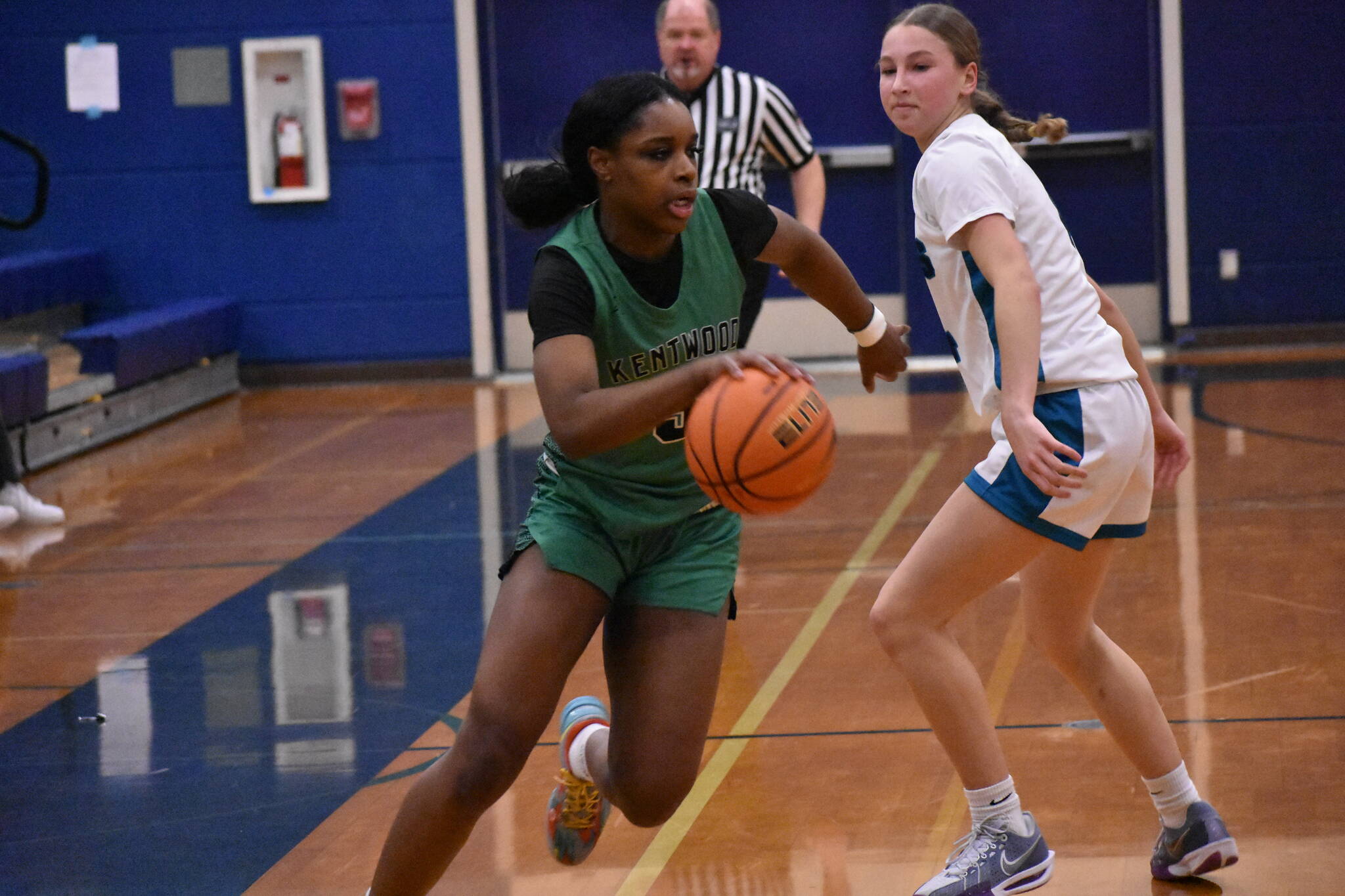 Kentwood’s Jessica Ajayi dribbles the ball up the floor. Ben Ray / The Reporter