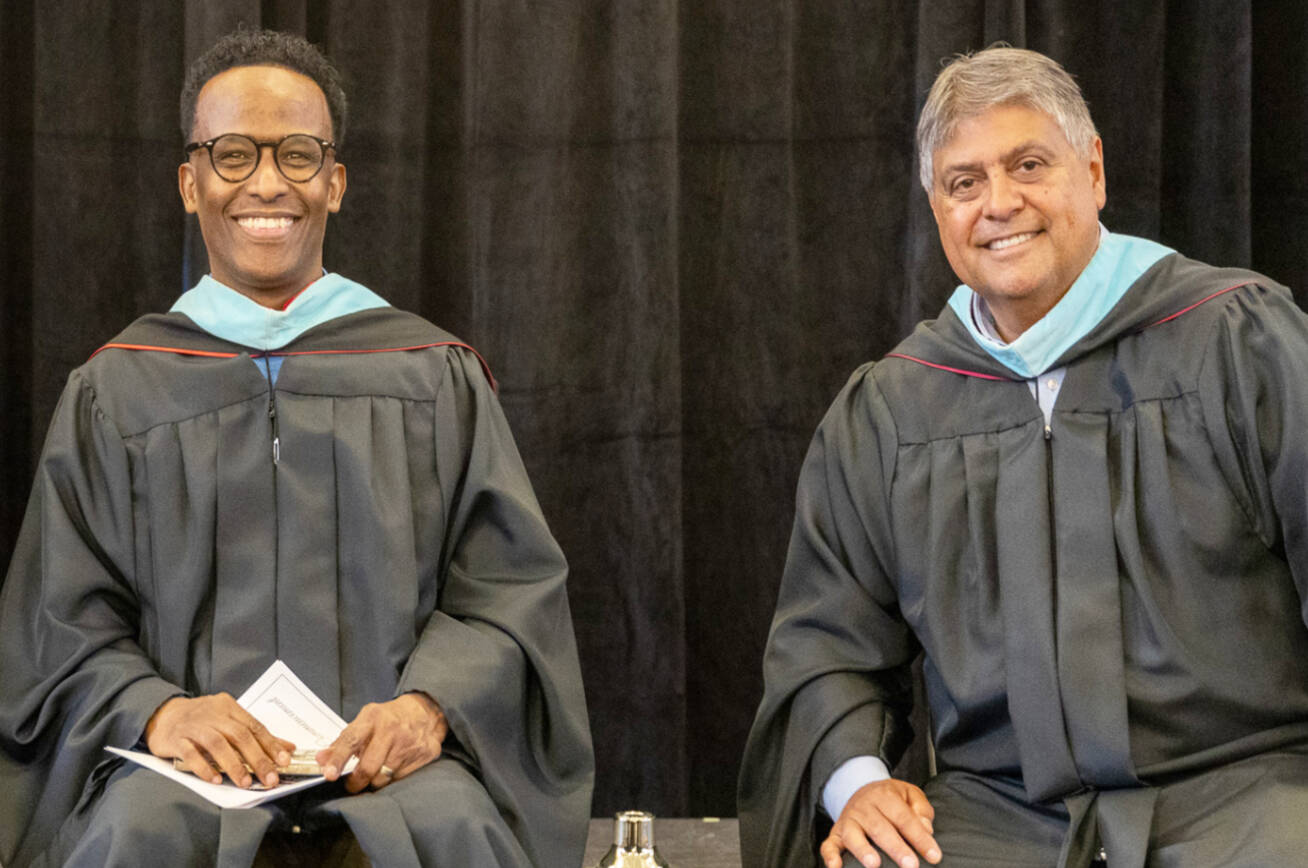 Kent School District Board Director Awale Farah, left, and Superintendent Israel Vela at a high school graduation last summer. COURTESY PHOTO, Kent School District