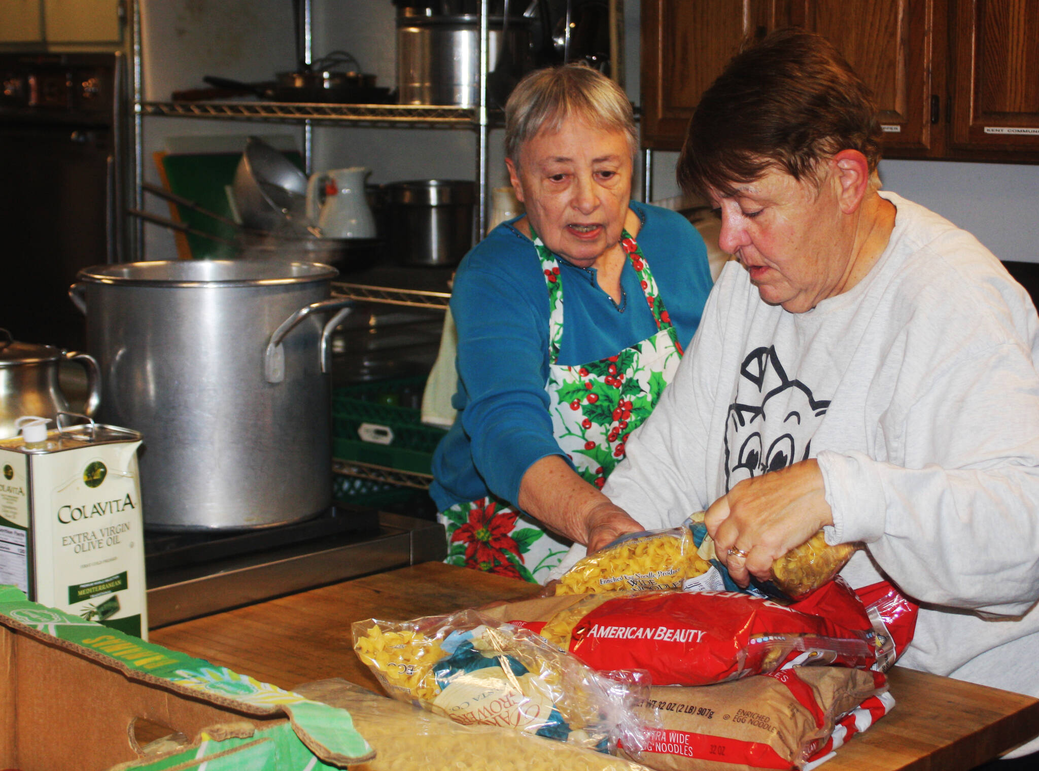 Nancy Turner, left, and Cathy Corrado, discuss preparations for the Dec. 16 Monday Night Supper. STEVE HUNTER, Kent Reporter