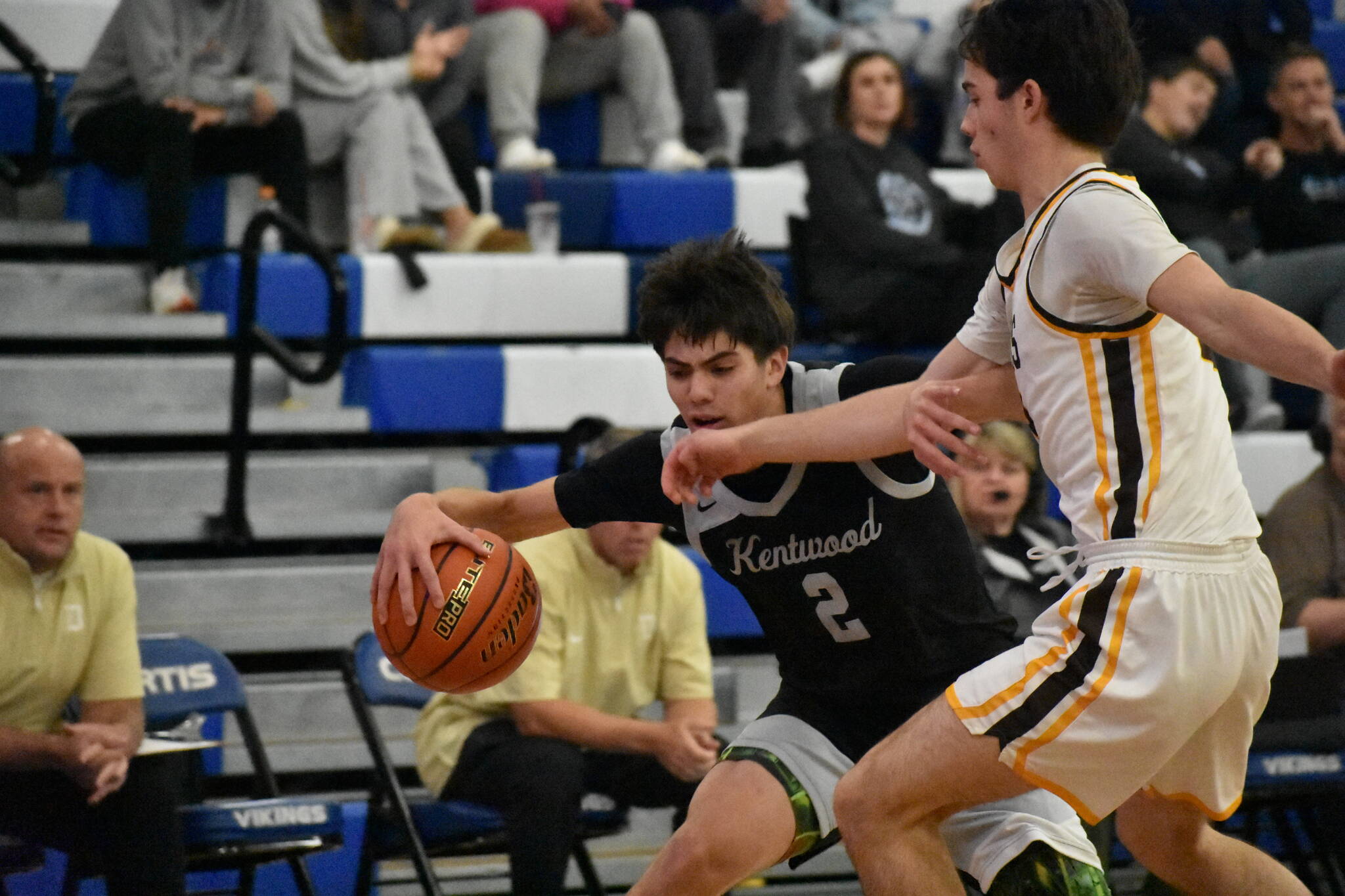 Kentwood’s Brandon Tagle fights against a Davis defender. Ben Ray / The Reporter