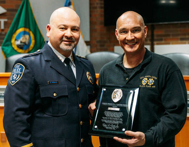 Kent Police Chief Rafael Padilla, left, honors retiring Detective Tim Ford during a Dec. 19 ceremony at City Hall. COURTESY PHOTO, Kent Police