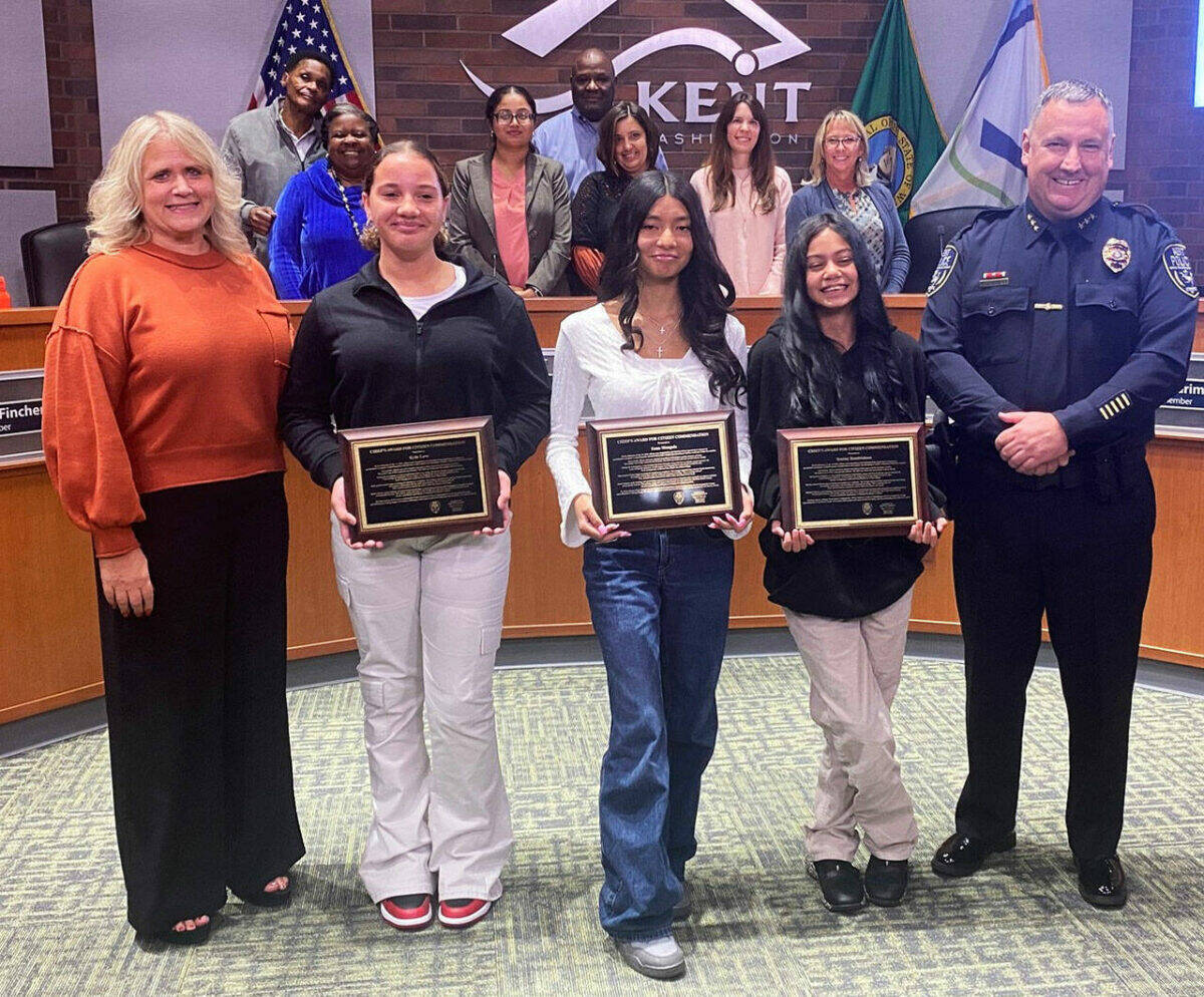 Kent Mayor Dana Ralph and Kent Police Deputy Chief Matt Stansfield pose Sept. 17 at the City Council meeting with the three girls who helped save a 6-year-old girl from an alleged attempted kidnapping July 16 at the Meridian Green Apartments. COURTESY PHOTO, City of Kent