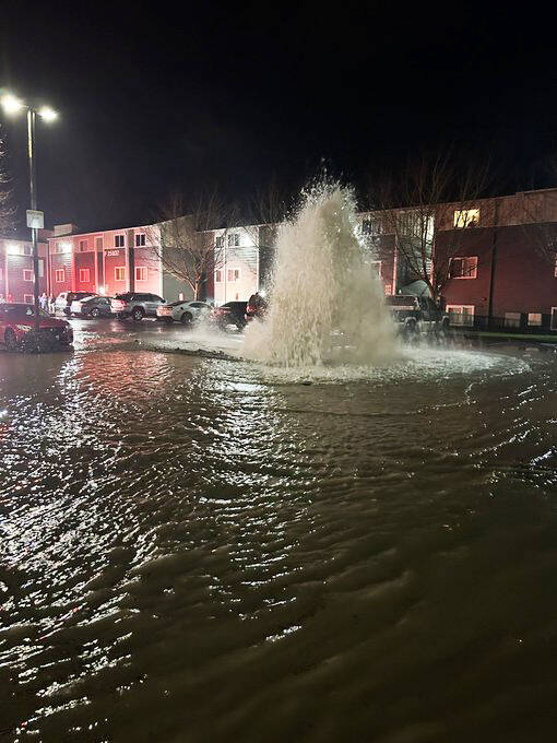 COURTESY PHOTO, Puget Sound Fire
Water flows out of a fire hydrant after being struck by a car Jan. 3 at the Appian Way Apartments on Kent’s West Hill.