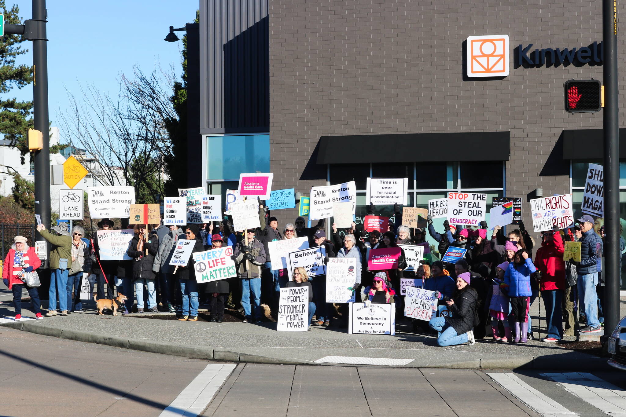 Fifty protesters held up a variety of signs at the Renton location for the Jan. 18, 2024 Women’s March and People’s March. Photo by Bailey Jo Josie/Sound Publishing.